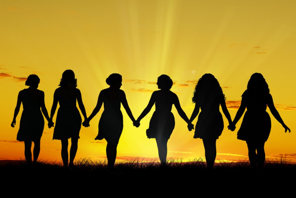Silouette of six young women, walking hand in hand
